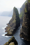 Vágar island, Faroes: Geituskorardrangur - a towering basalt stack standing 116m above the ocean, by the vertical cliff face - photo by A.Ferrari