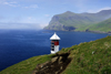 Sørvágsfjørður fjord, Vágar island, Faroes: lighthouse perched over the sea - solar power operated - photo by A.Ferrari