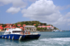 Gustavia, St. Barts / Saint-Barthélemy: a divers' boat returns to the harbour - museum and local government buildings in the background - tip of Gustavia Peninsula - photo by M.Torres