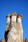 Cappadocia - Göreme, Nevsehir province, Central Anatolia, Turkey: three basalt boulders over tuff cones - fairy chimneys - Valley of the Monks - Pasabagi Valley- photo by W.Allgöwer
