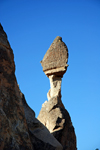 Cappadocia - Göreme, Nevsehir province, Central Anatolia, Turkey: fairy chimney near the end - boulder in precarious balance over a thin spire of rock - Valley of the Monks - Pasabagi Valley - photo by W.Allgöwer